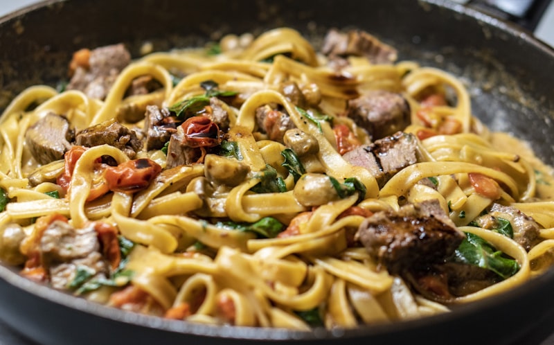 Pasta wird in der Pfanne geschwenkt